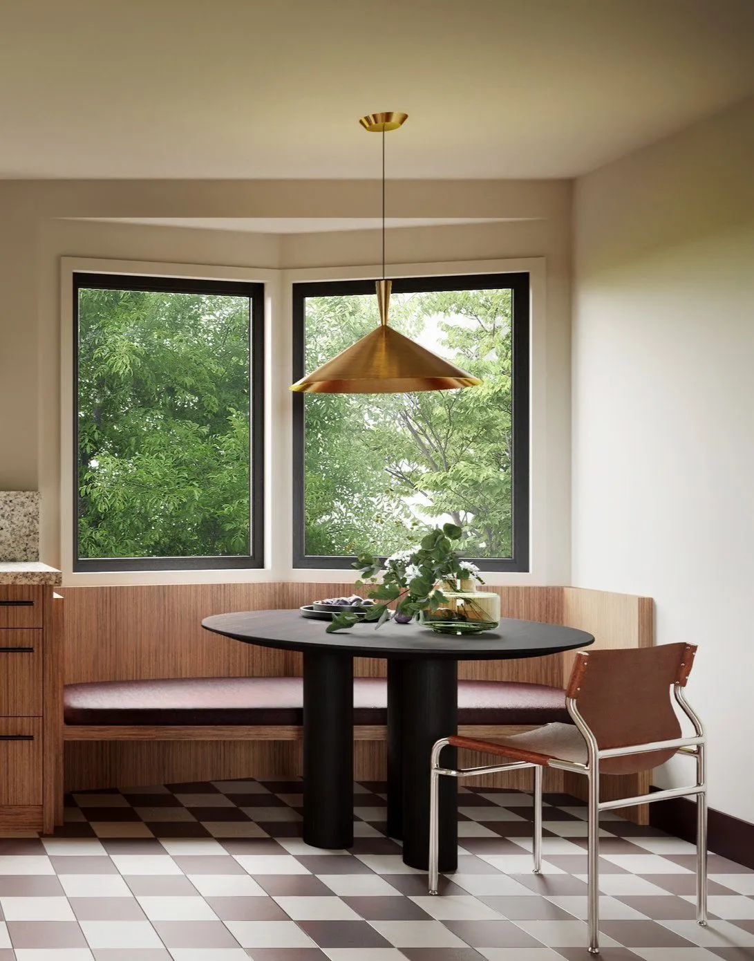 Breakfast nook in a corner bay window with round black pedestal table, built-in wood banquette and brass cone pendant — Grounding roots - Casa de Tarin interior design