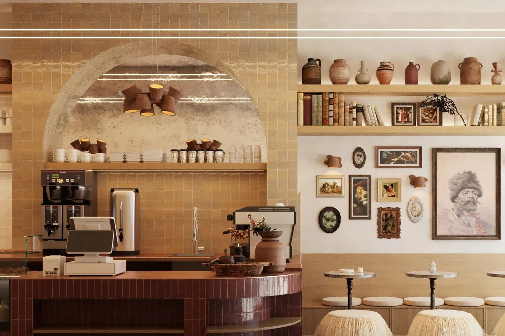 Franko & Coffee bar: burgundy-tiled counter beneath a honey zellige arch, open shelves of ceramics and fringed stools