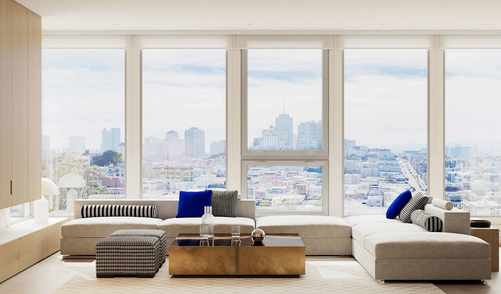 Grey modular sectional with cobalt and houndstooth pillows around a brass-clad coffee table, floor-to-ceiling windows onto the San Francisco skyline — Minimalist Glamour - condo