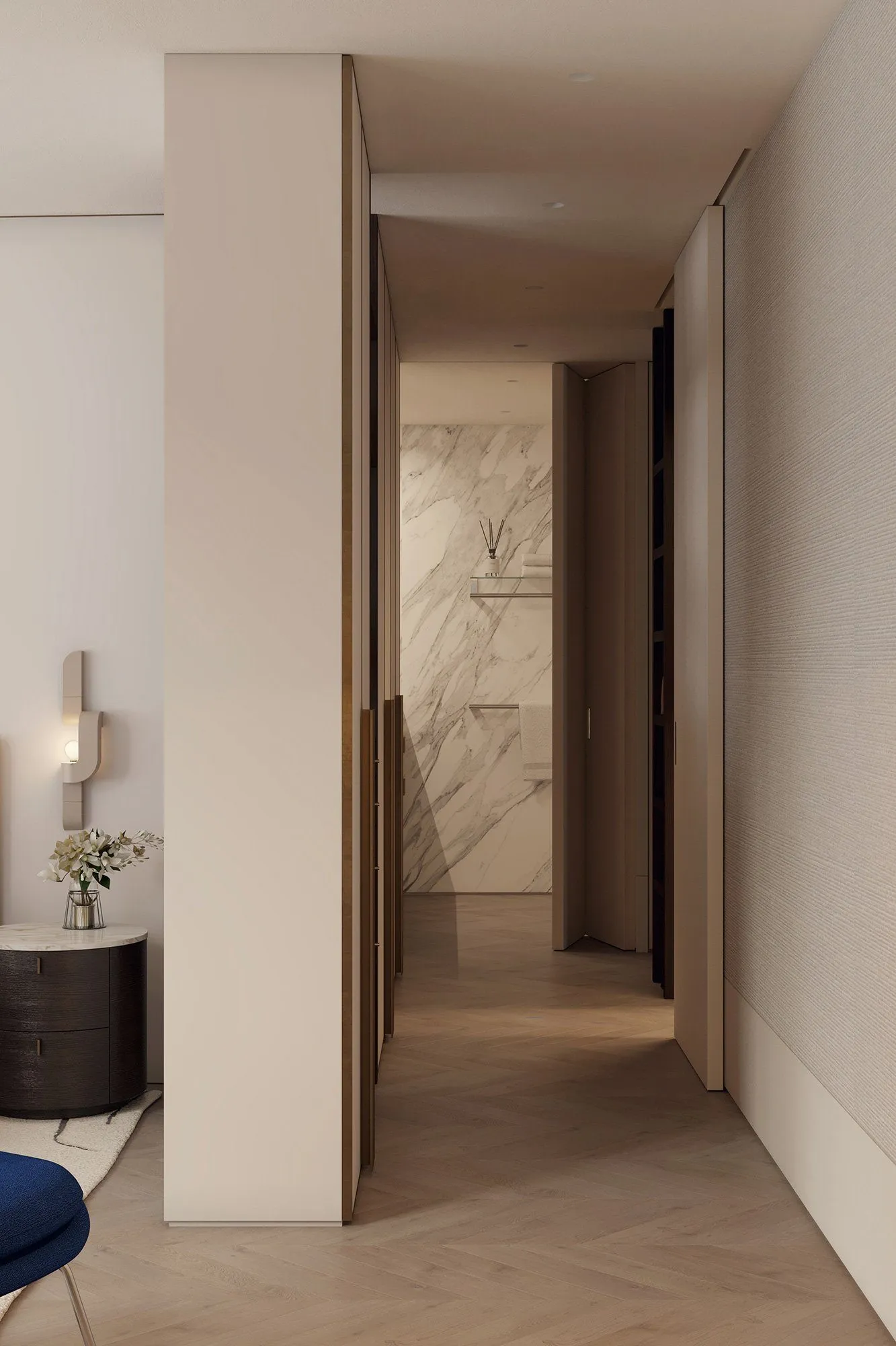 Bedroom hallway with oval nightstand and curved sconce, brass-edged wardrobe doors leading to a marble-lined bathroom — Minimalist Glamour - condo