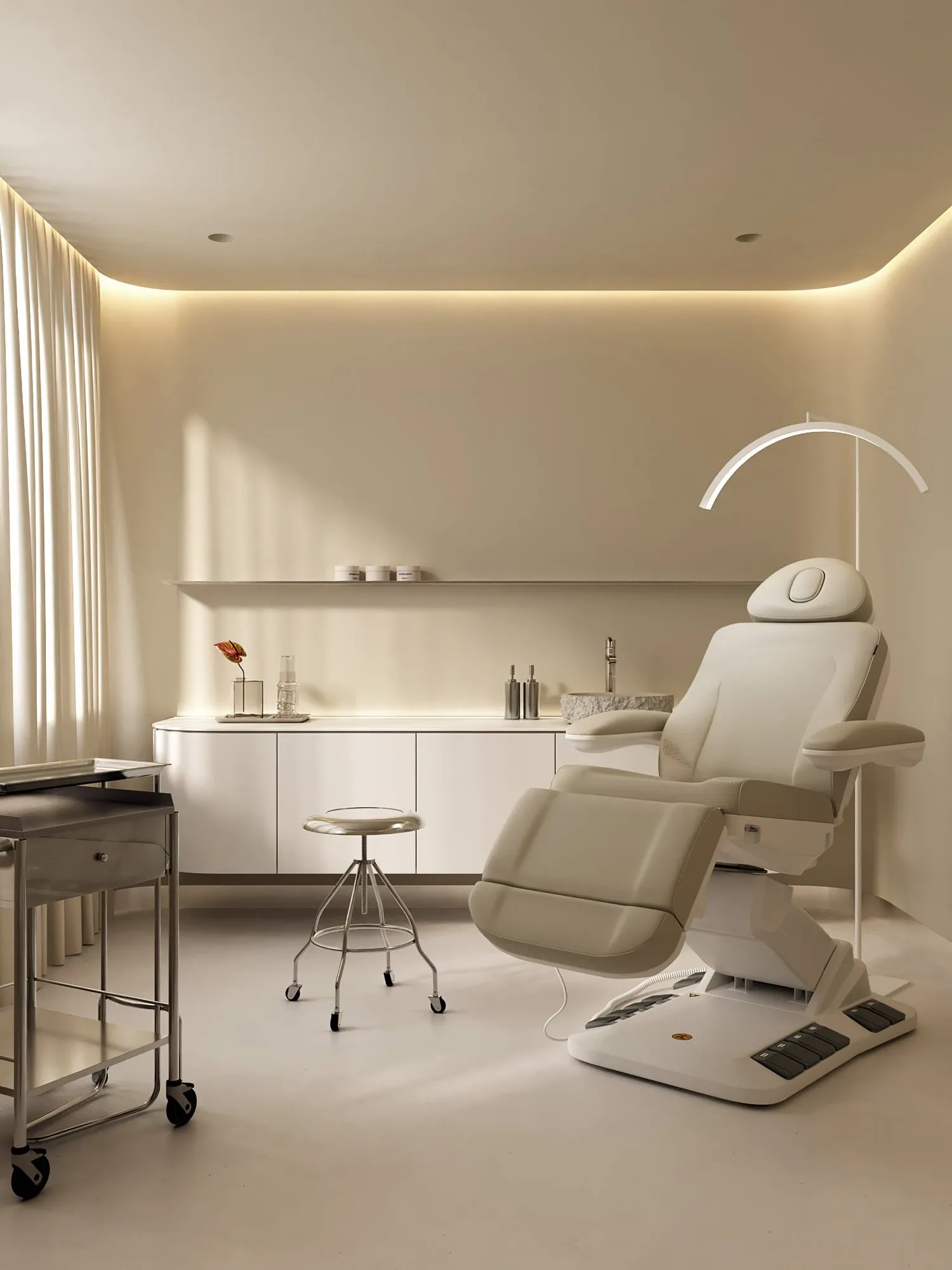 Rendering of a treatment room: chair with ring light, floating cabinetry, stainless cart and stool, cove lighting