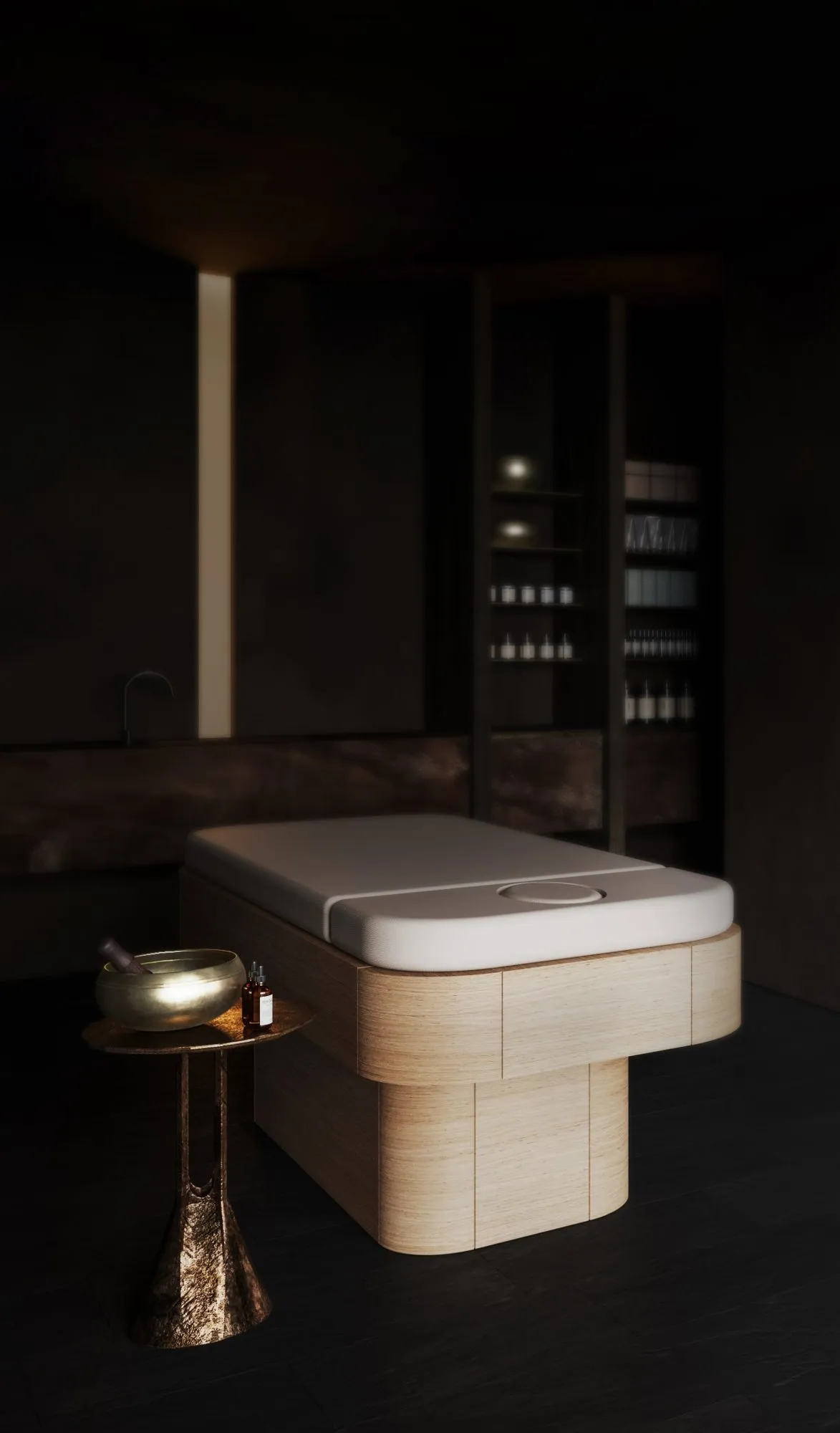 Rendering: dark treatment room with a pale wood massage table, brass lamp on a sculpted side table and backlit shelves of bottles