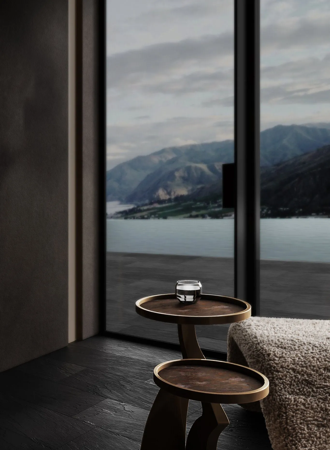 Rendering: two round wooden side tables by a full-height window with lake and mountain views, dark slate floor