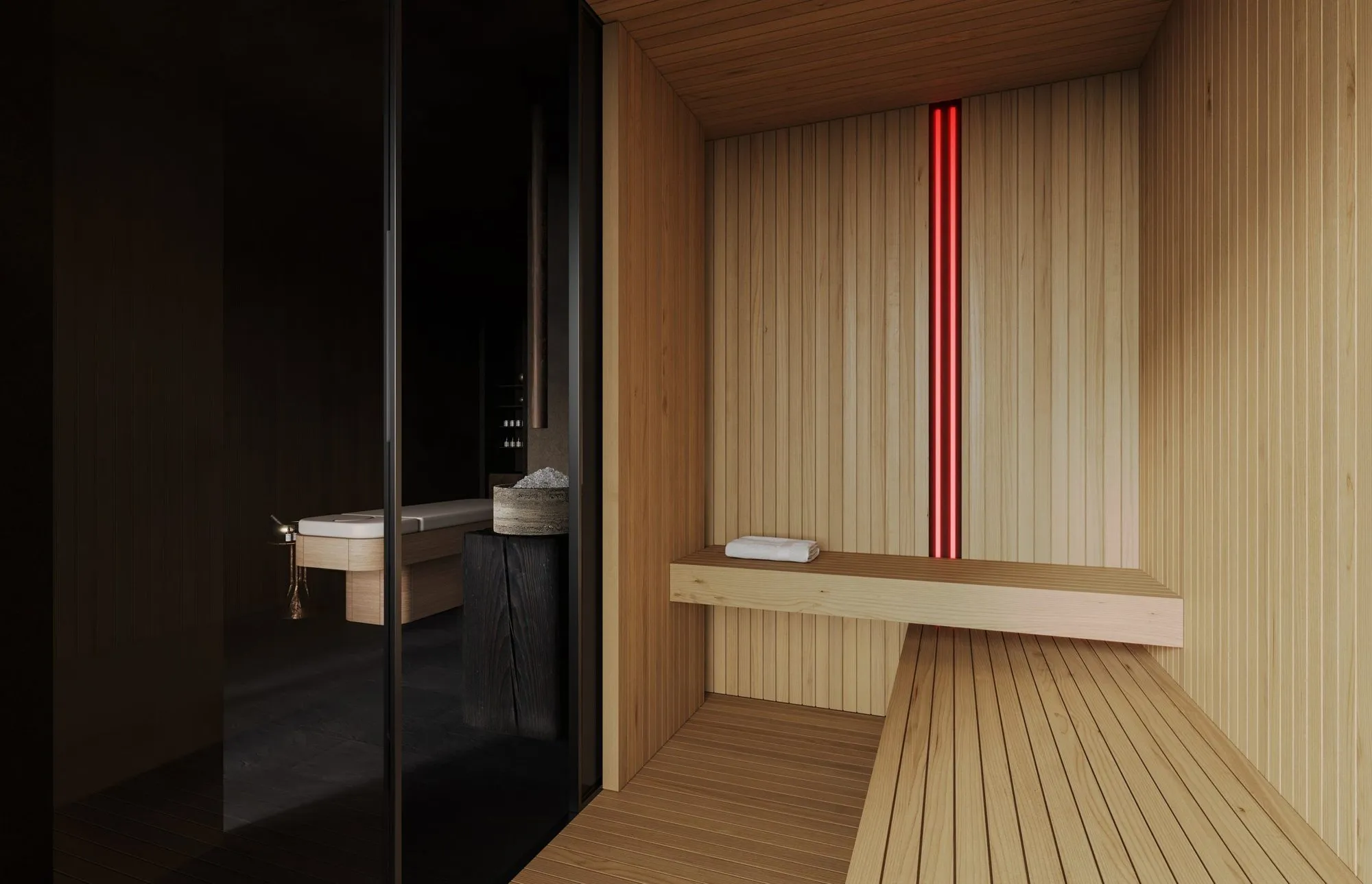 Cedar sauna interior with slatted walls, floating bench, rolled towel and a vertical strip of red light — Obsidian Oasis Spa