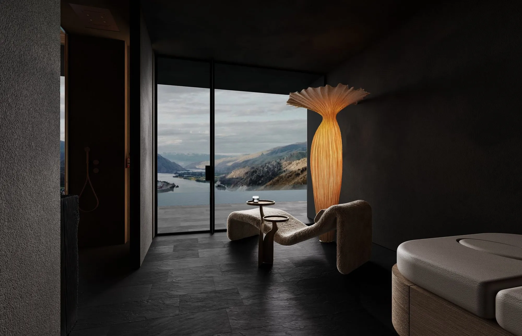 Relaxation room with slate floors and a sculptural glowing lamp, its glass wall opening to a lake and mountain panorama — Obsidian Oasis Spa