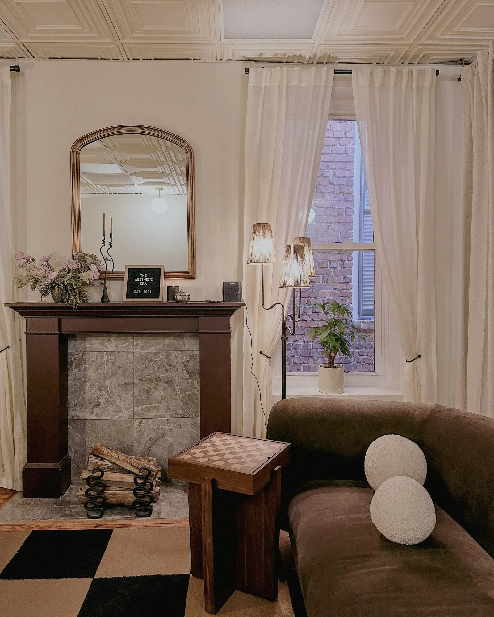 Concept collage of the lounge with brown velvet chair, slipcovered armchair, antique glazed cabinet and beaded round mirror — The Aesthetic Era - Medical SPA interior design