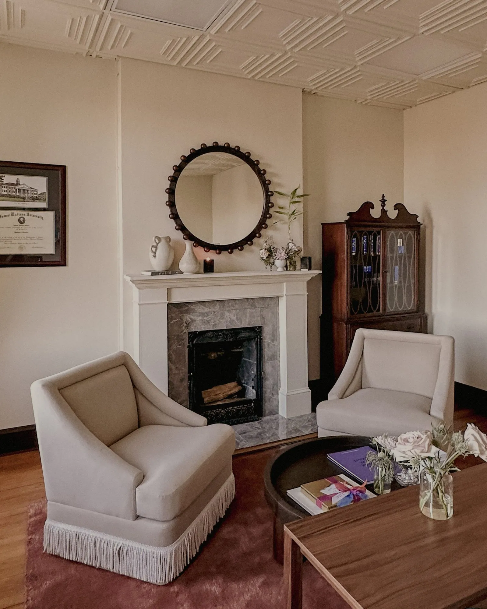 Waiting area with curved velvet chairs and Art Deco details in a historic 1920s building — The Aesthetic Era Med Spa